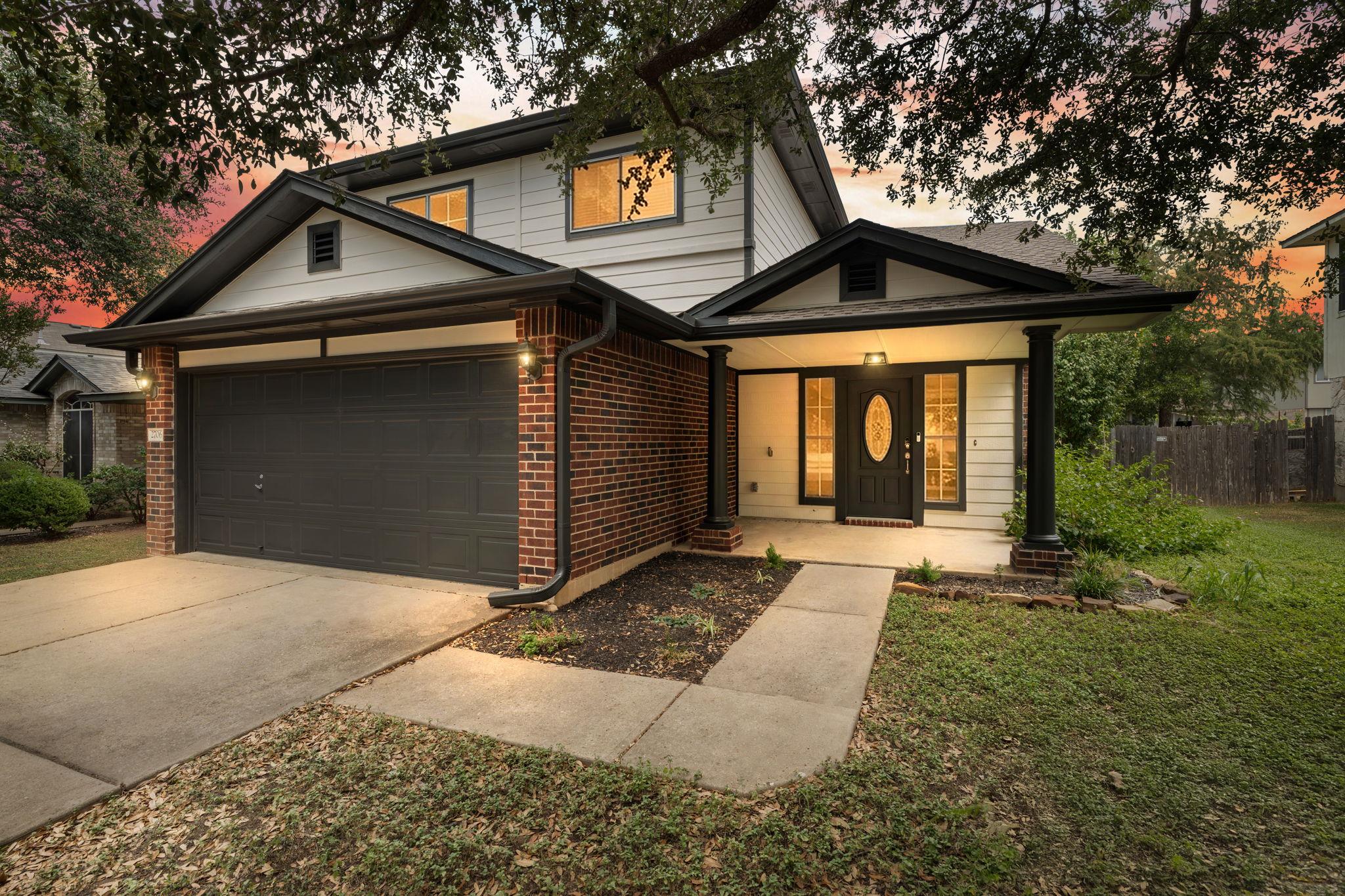 Stately columns flank the welcoming covered front