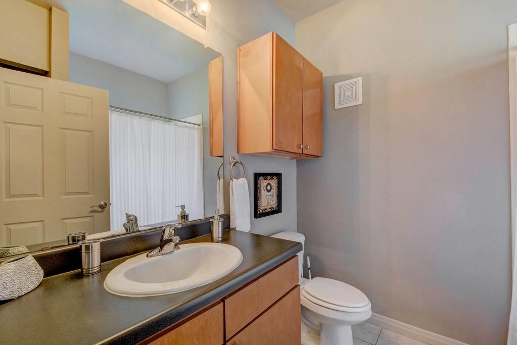 Bathroom with vanity, curtained shower, and light