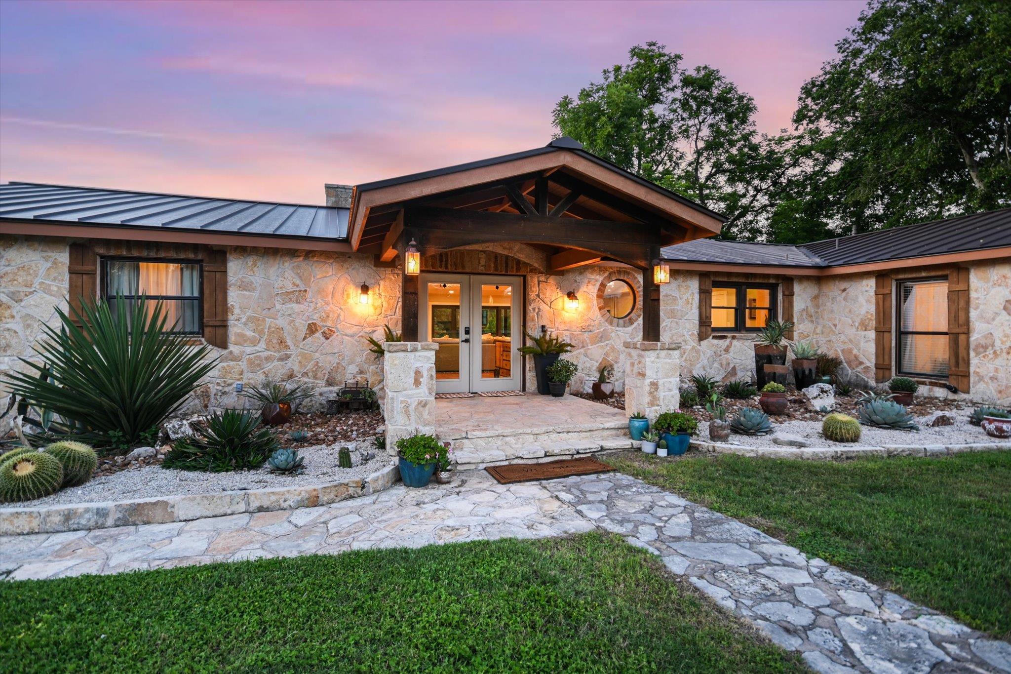 A stone-clad home welcomes with an inviting porch