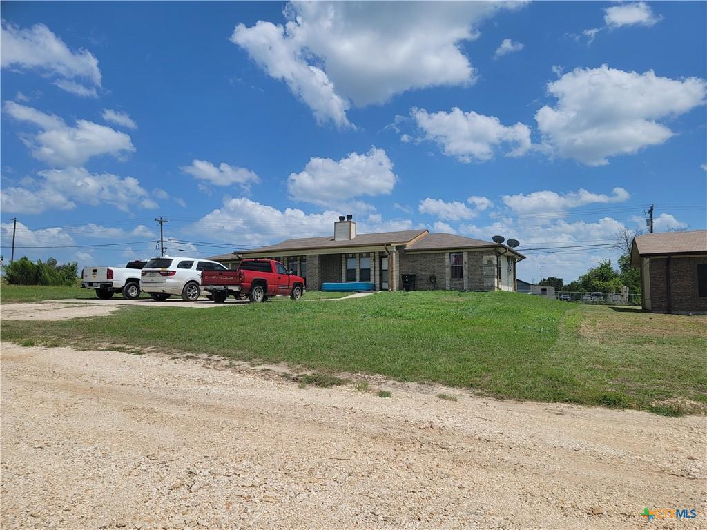 A sprawling brick ranch with a classic chimney, o