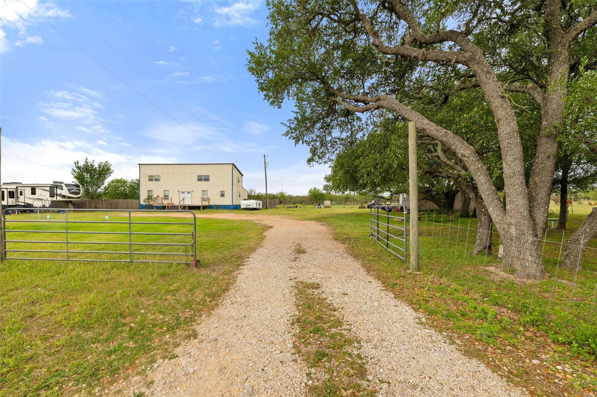 A long gravel driveway guides the way to a spacio