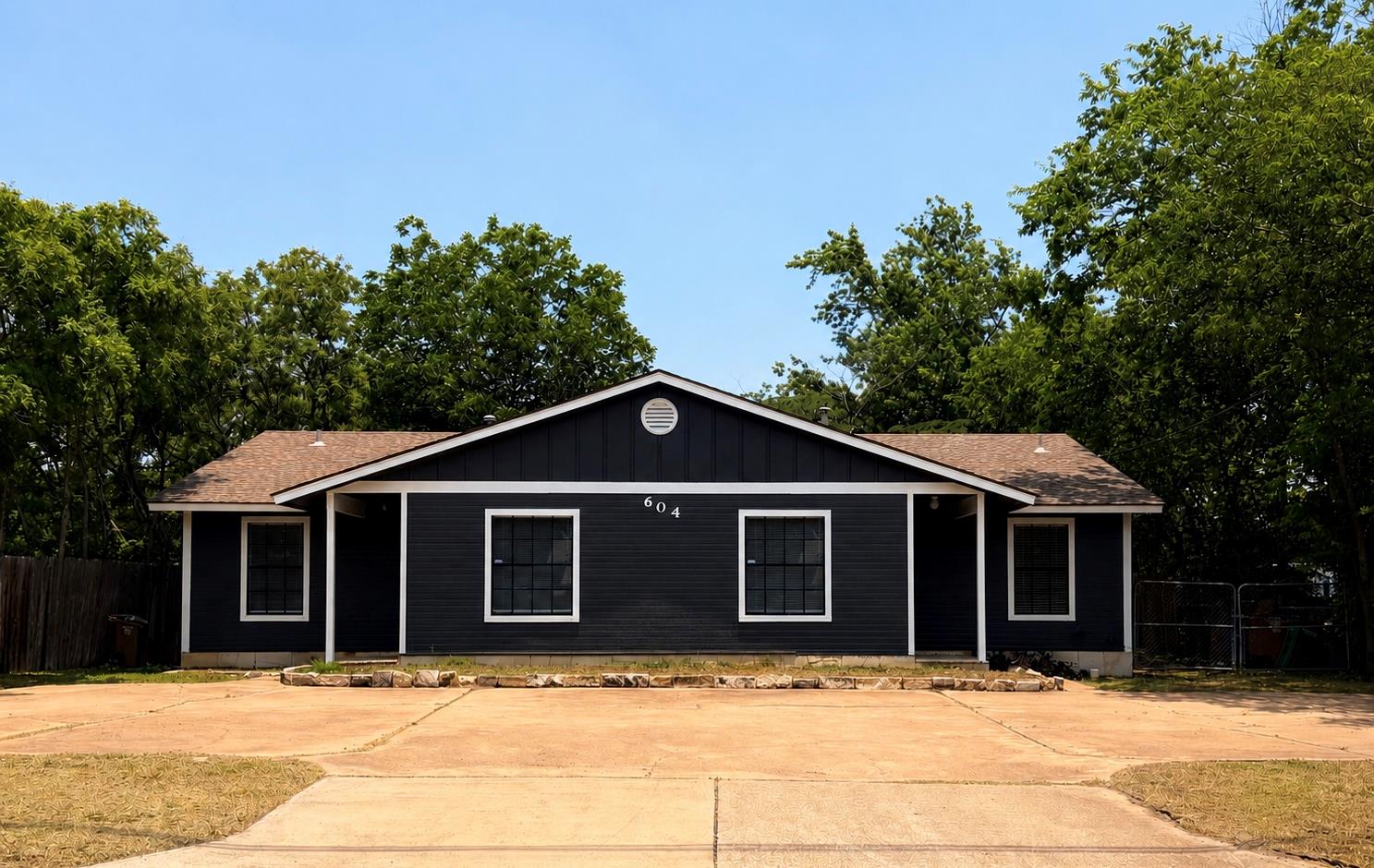 A dark-hued facade with crisp white trim offers a