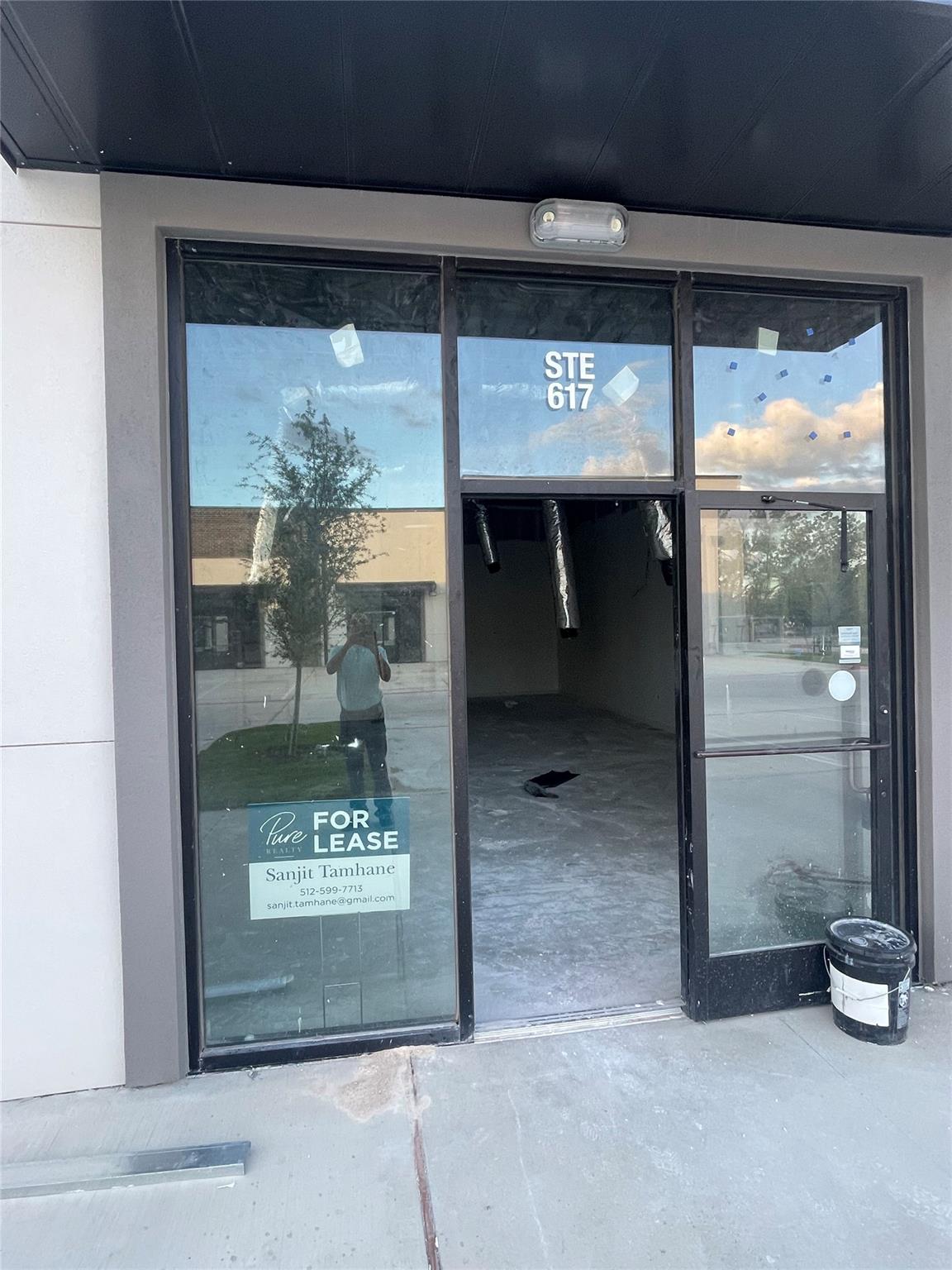 A well-lit commercial entrance with broad glass d