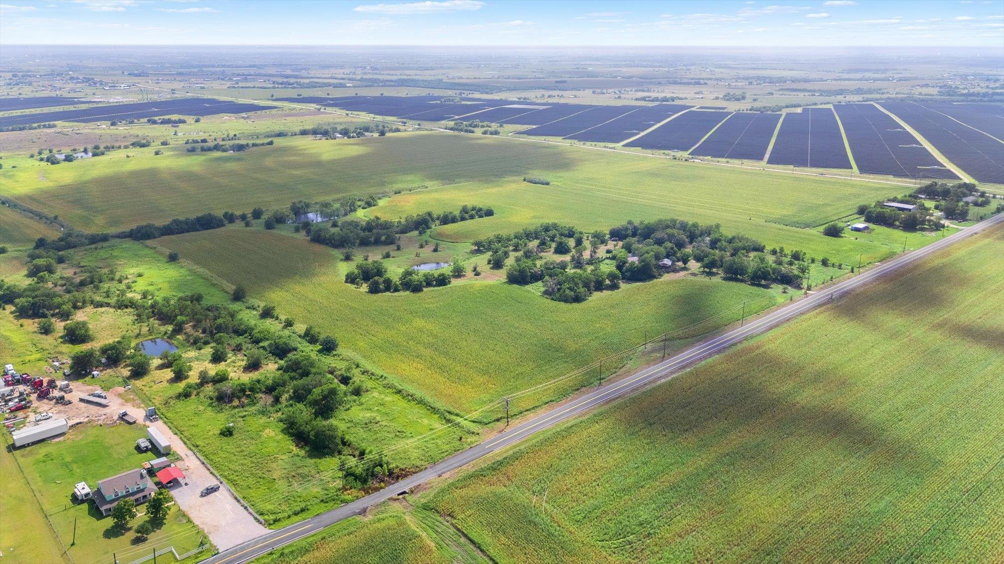 Vast green fields stretch to the horizon, featuri