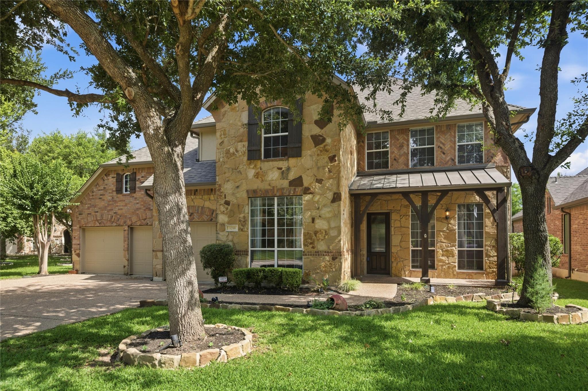 A traditional brick and stone facade welcomes wit