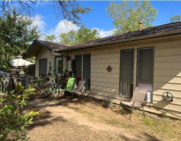 A modest side yard with a sturdy wooden fence and