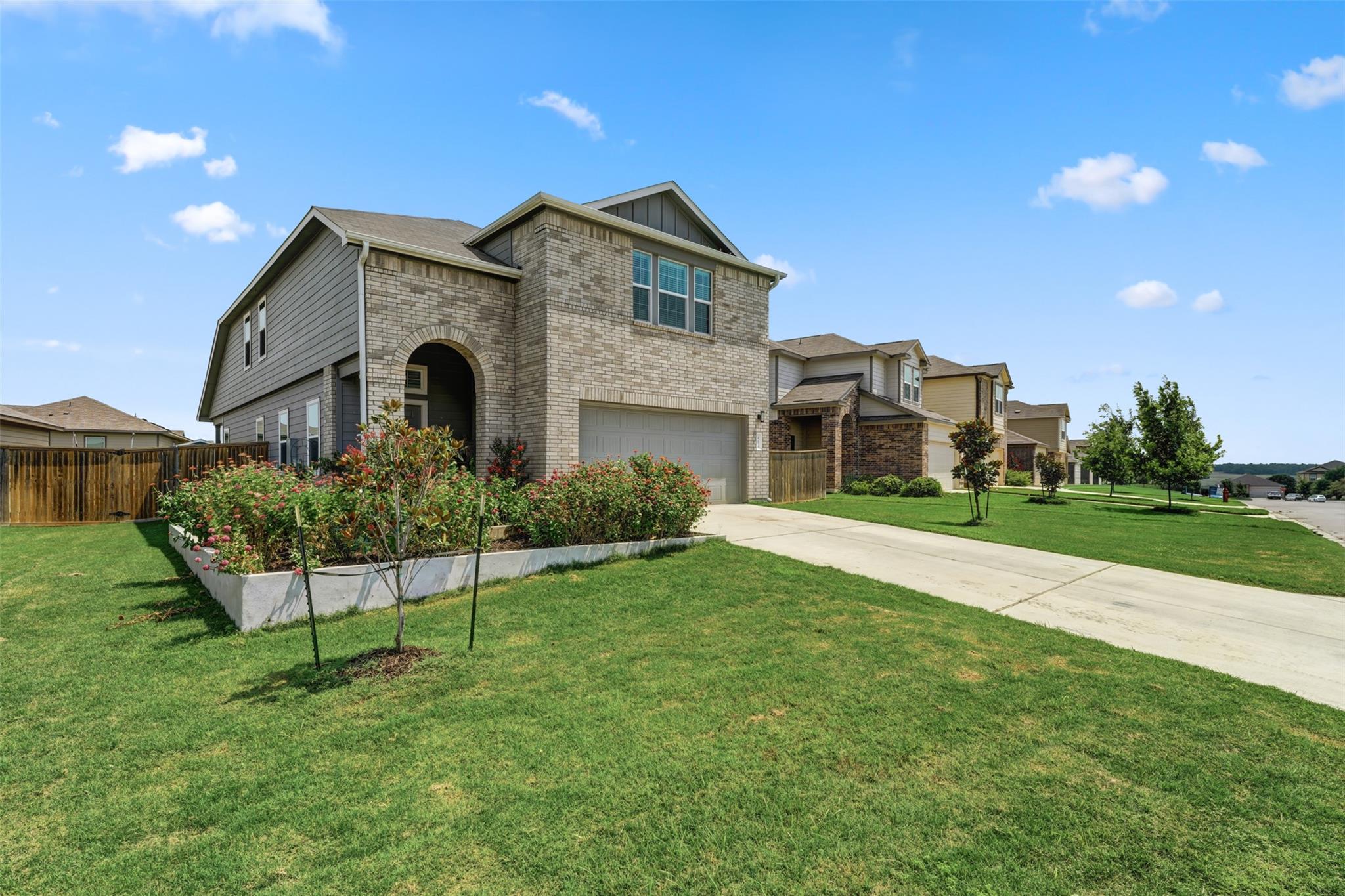 A well-maintained lawn introduces this inviting r