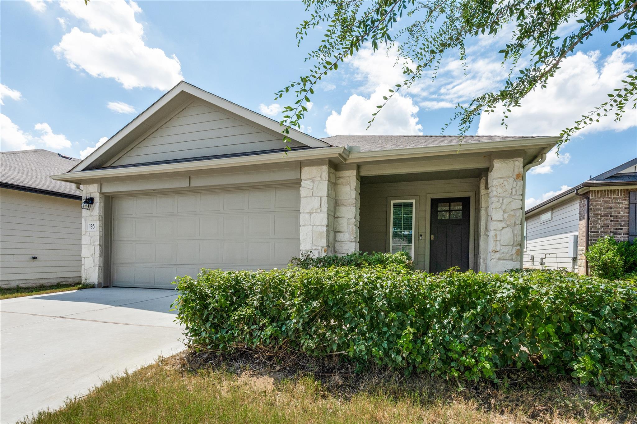 A single-story home with a light gray facade, att