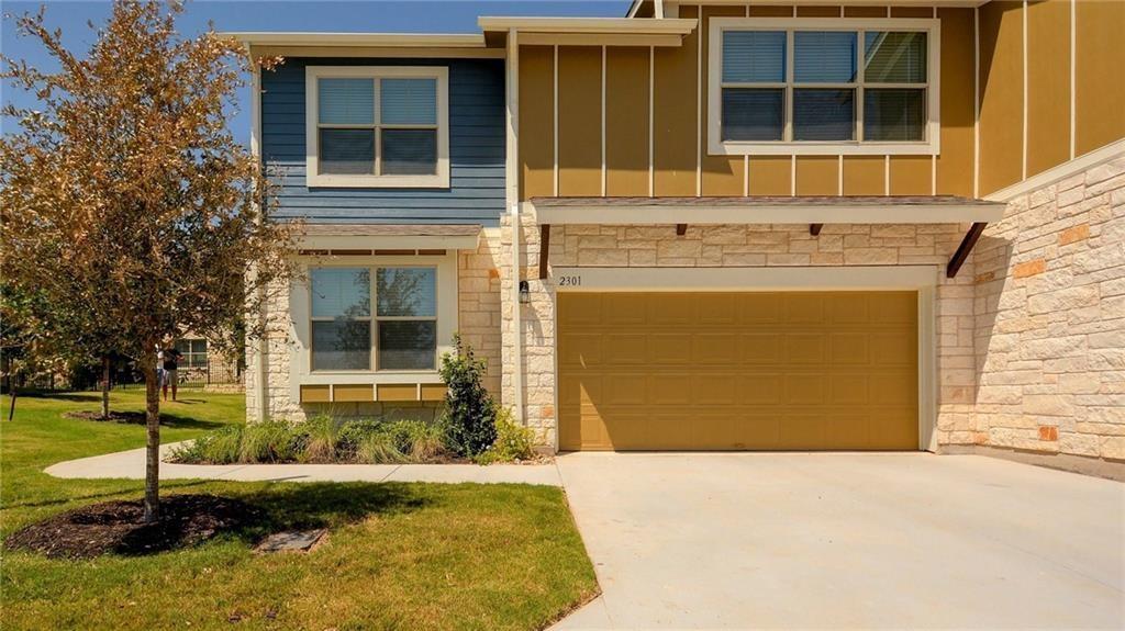 A striking modern facade features stone and sidin