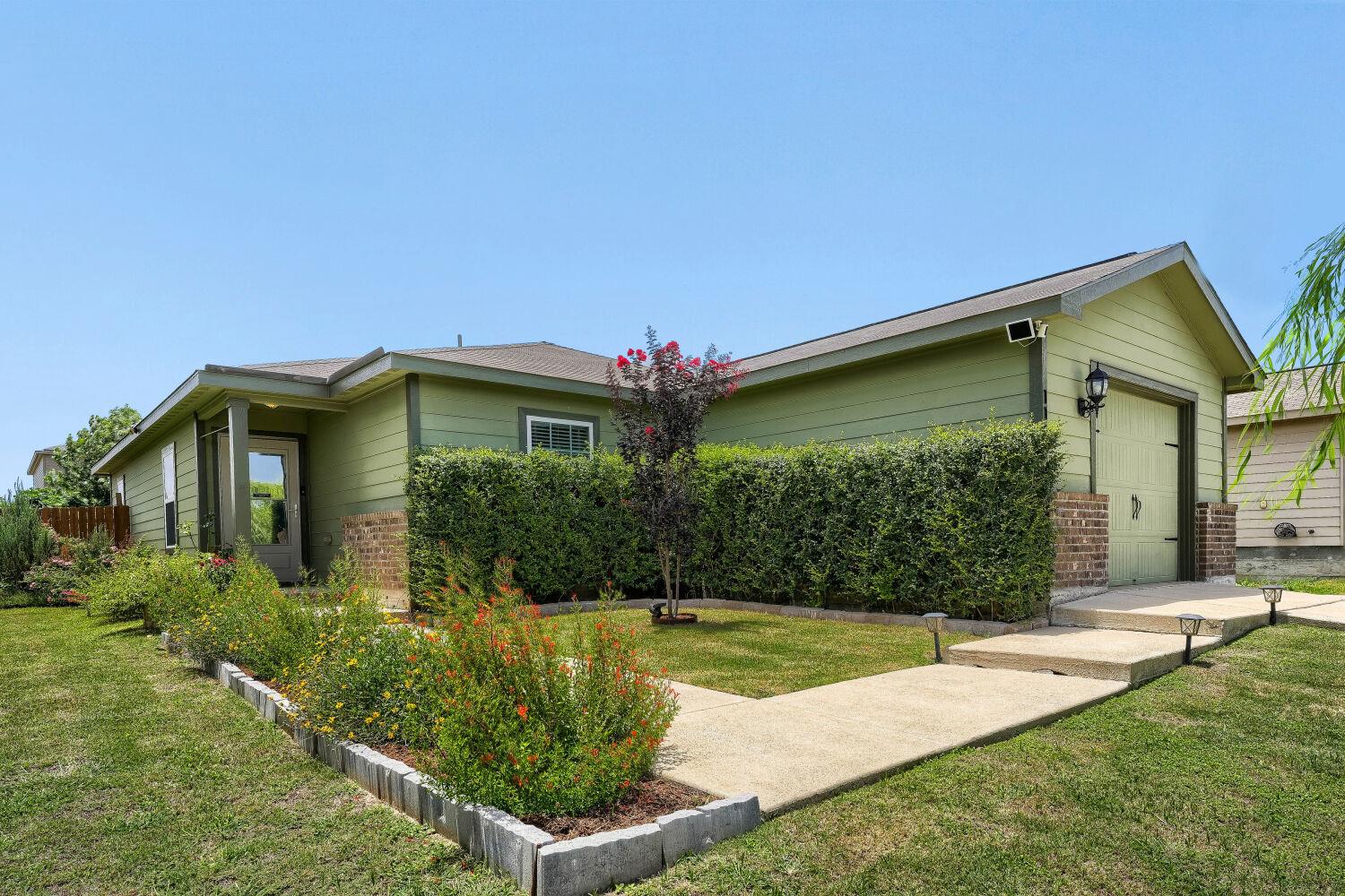 A cheerful facade featuring a well-kept lawn, a v
