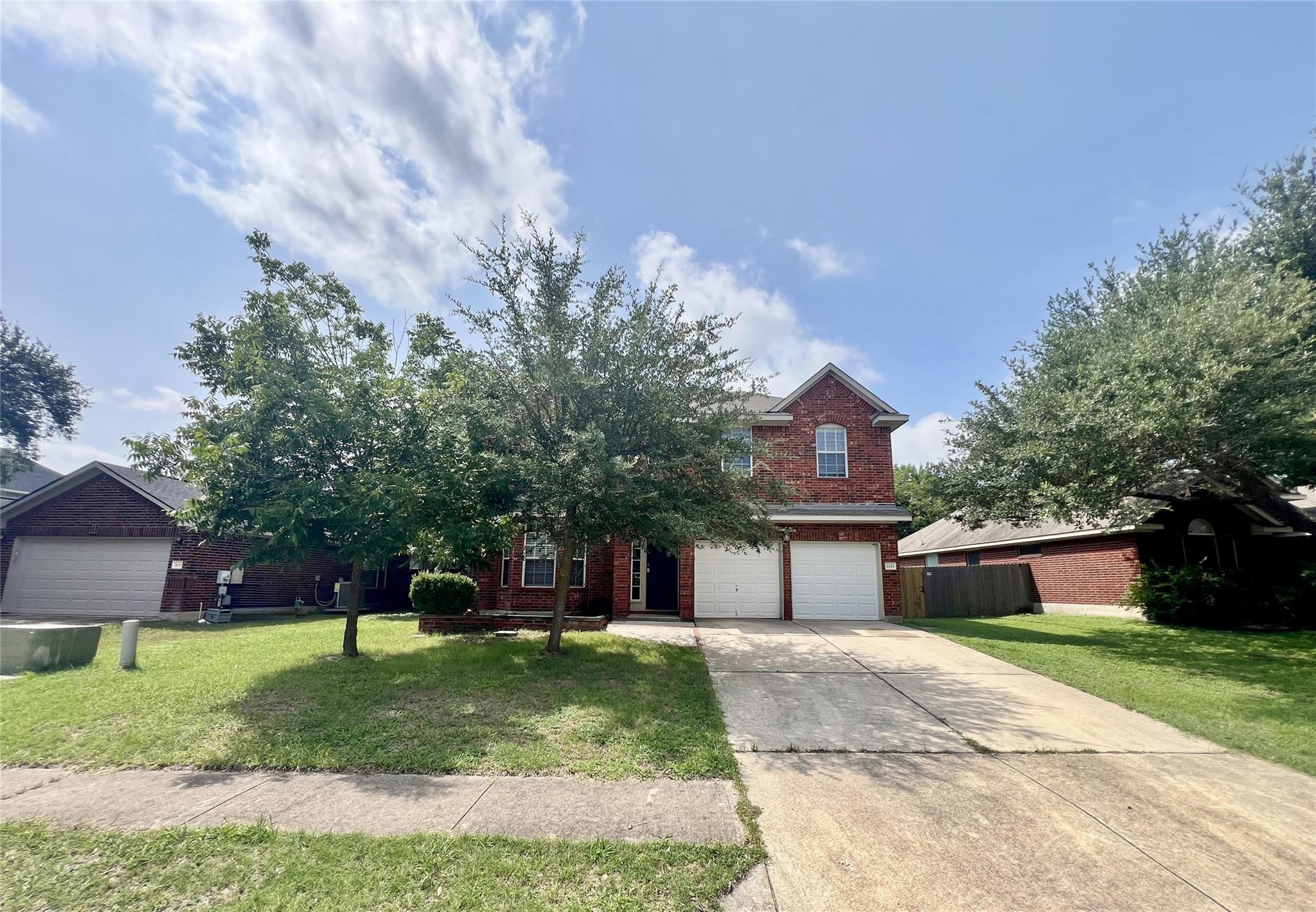 A classic brick exterior with a welcoming drivewa