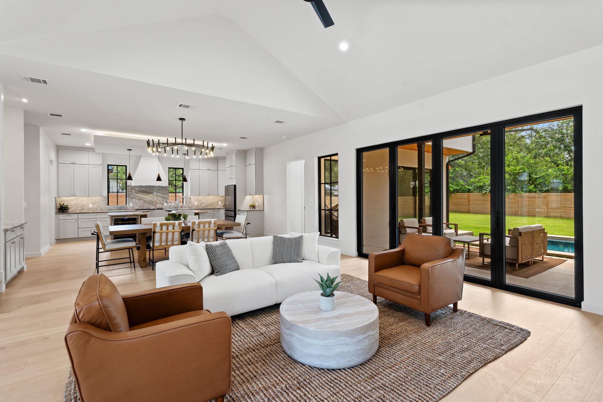 Bright, open-concept living space with vaulted ce