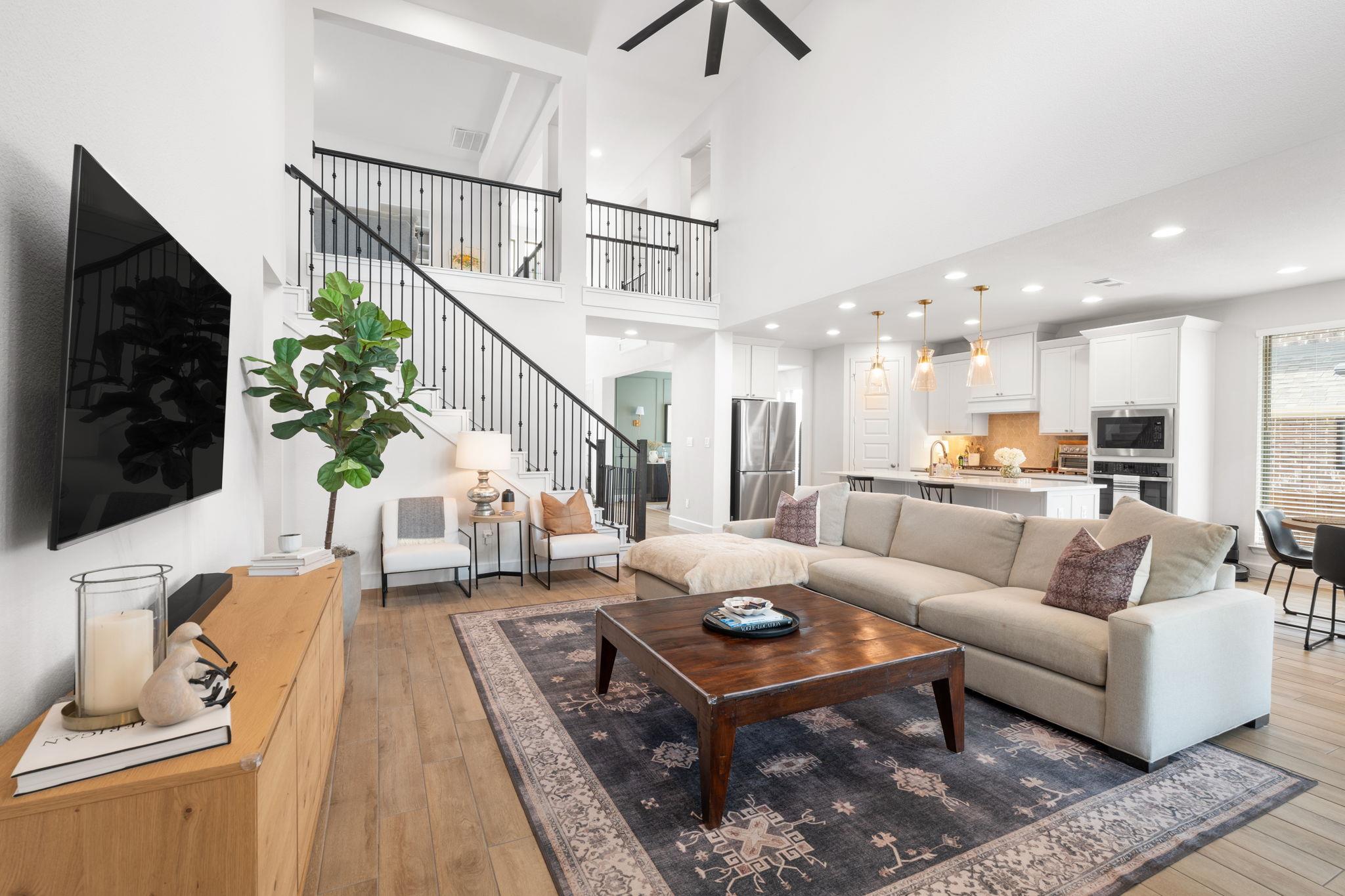A grand, naturally illuminated living room featur