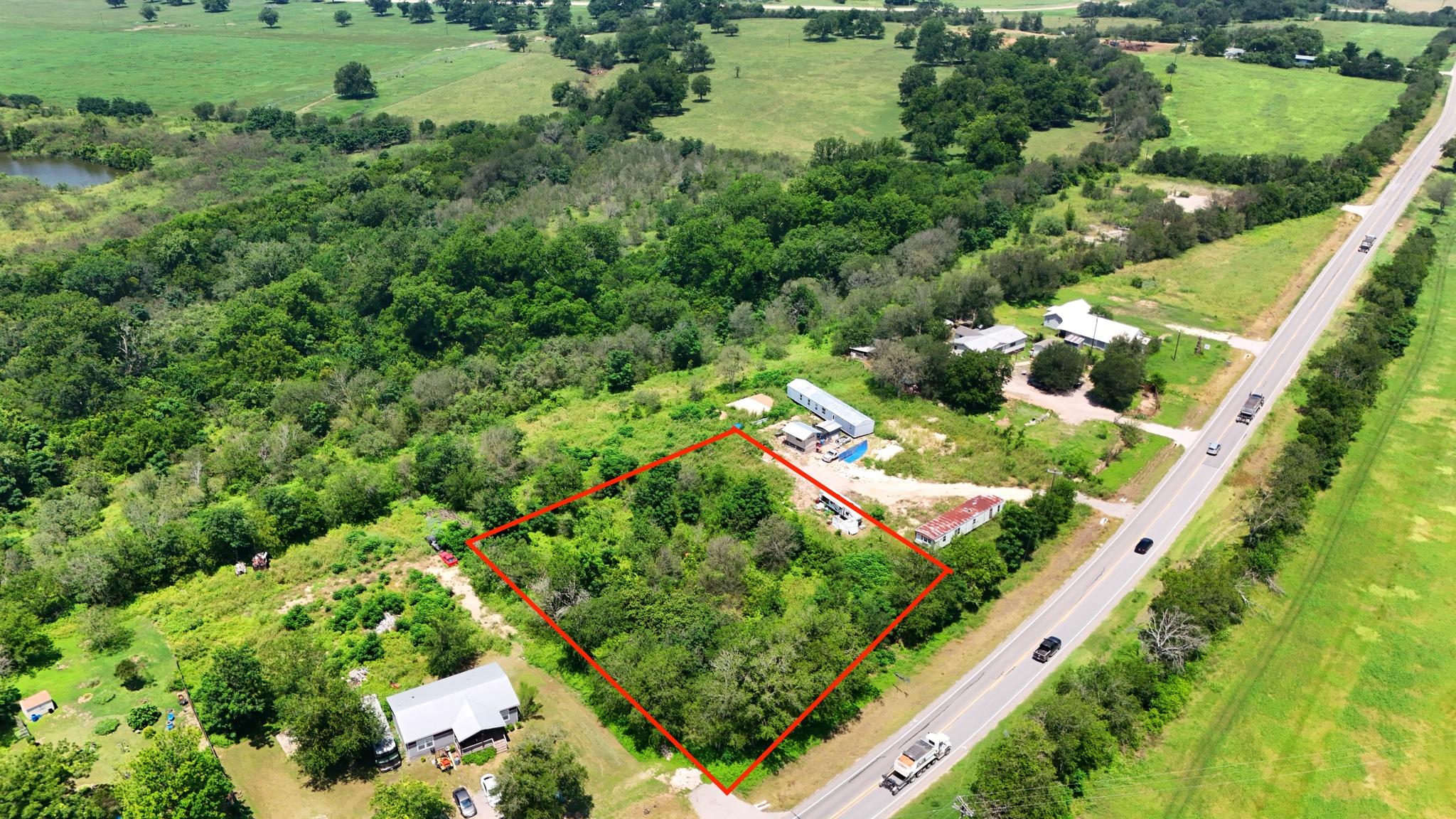 A spacious, verdant lot awaits your vision, perfe