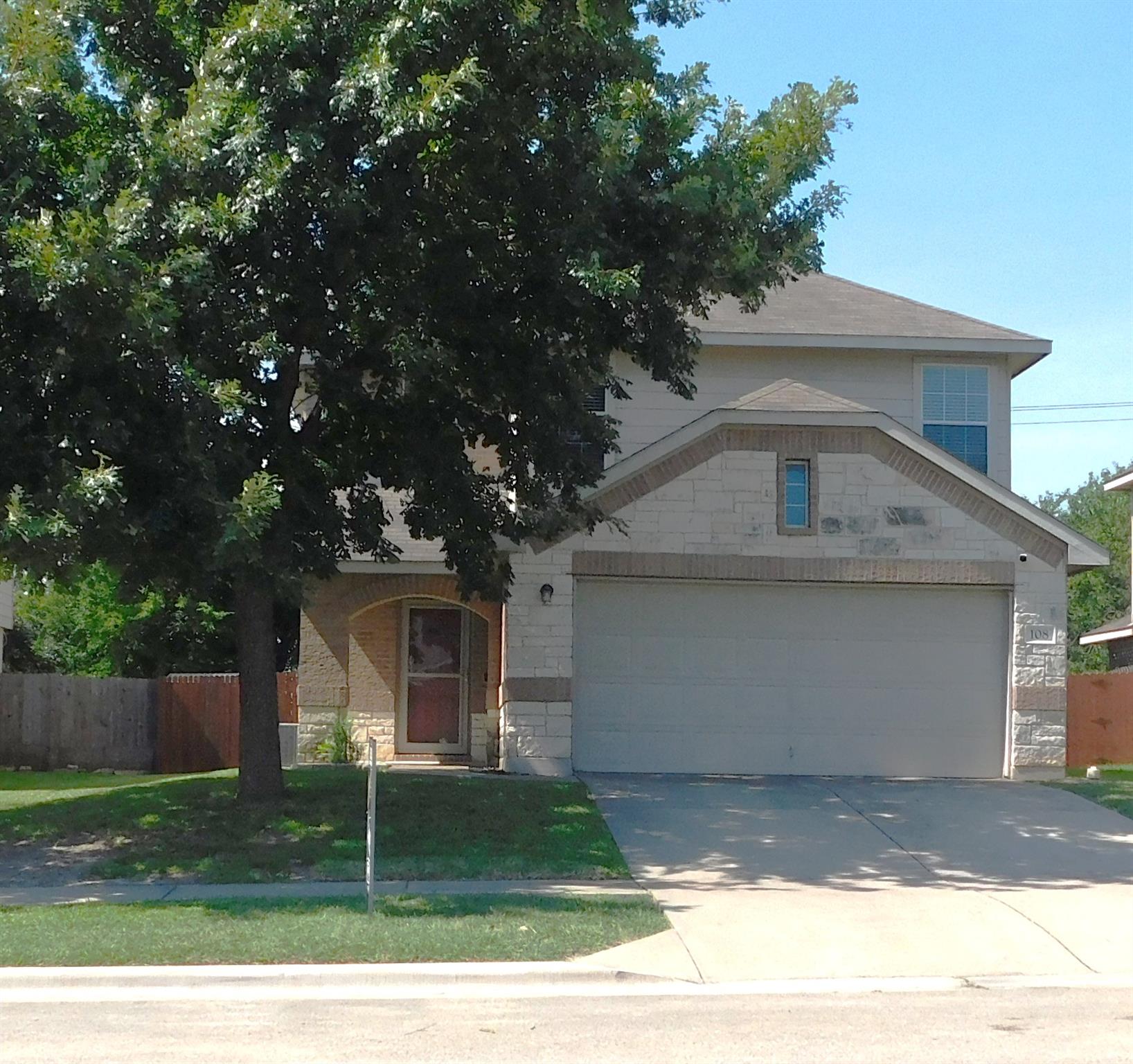 A well-maintained two-story residence with an att