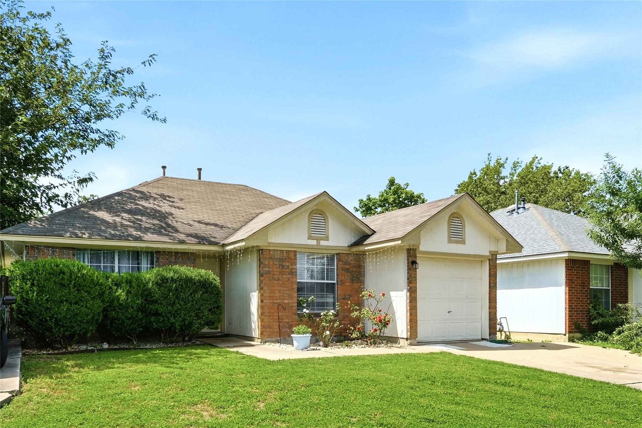 A classic brick and siding home with a welcoming 