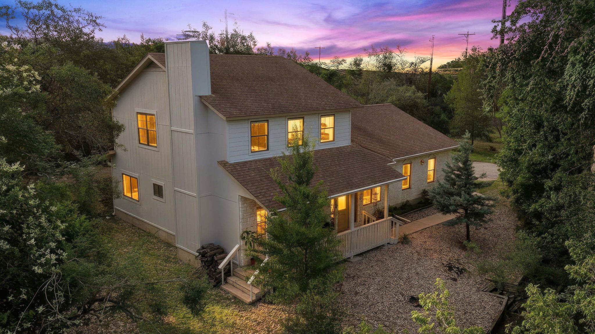 Perched amidst verdant trees, this charming resid