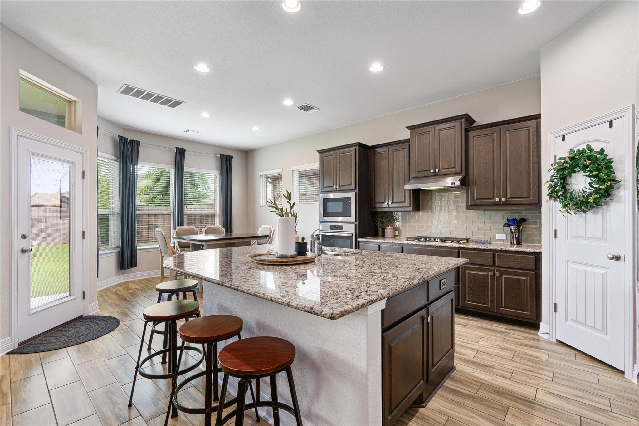 Granite counters and rich cabinetry define this m