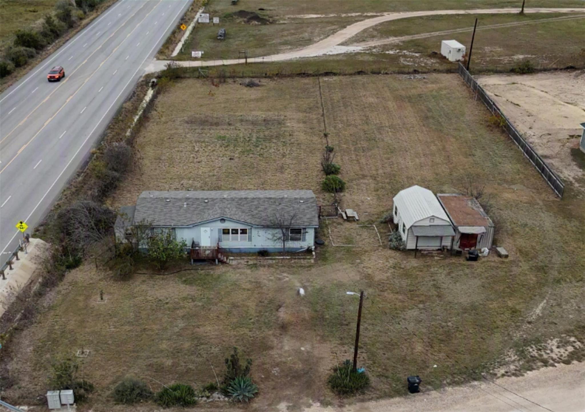 An aerial perspective reveals a rural property wi