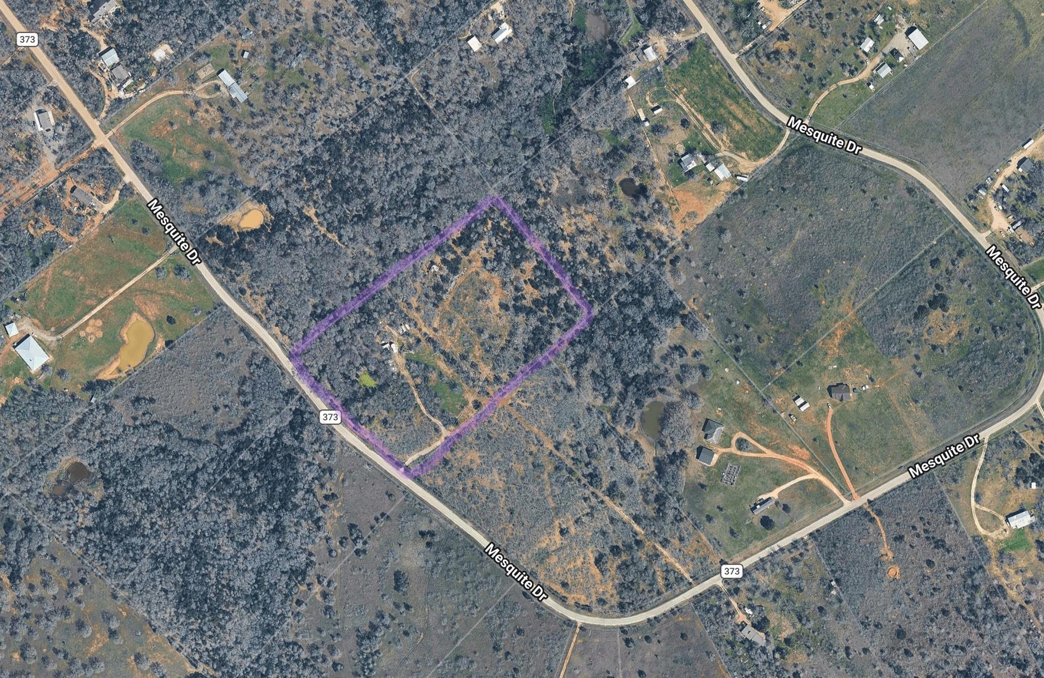 An aerial view captures the vast land parcel, bor