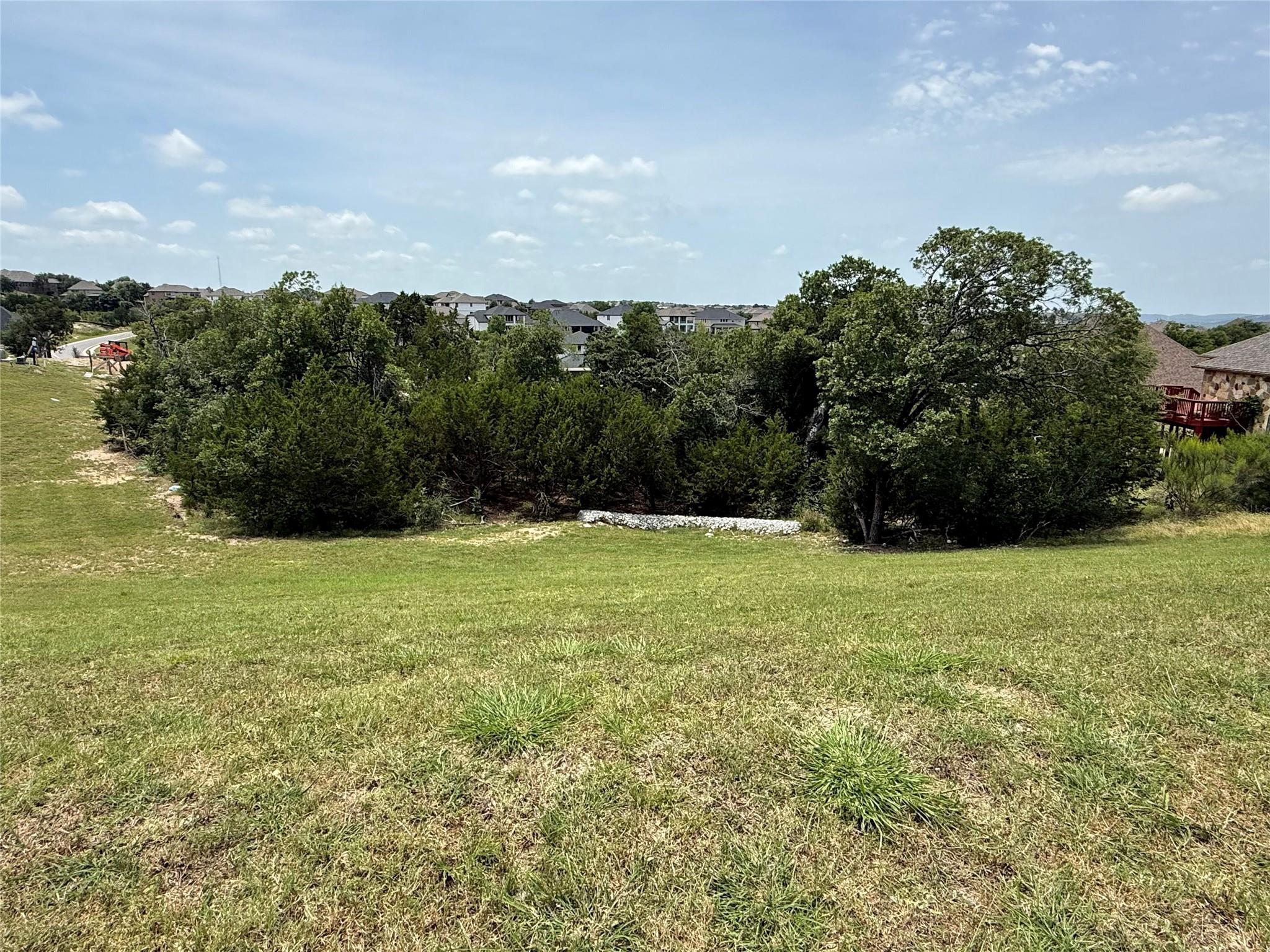 A gently sloping lot with abundant green space an