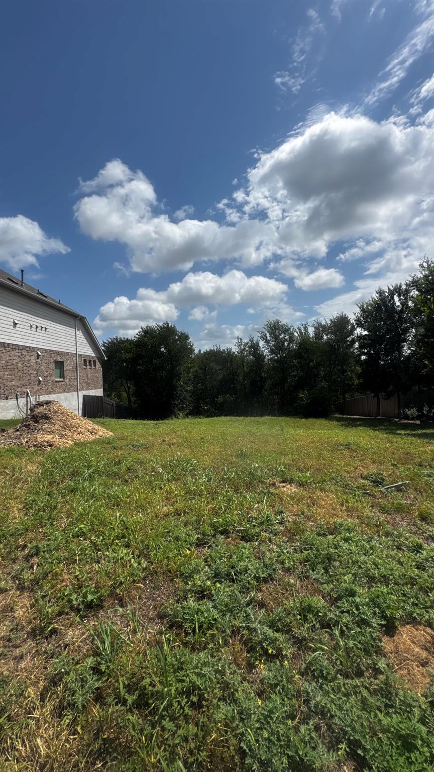 A spacious, verdant lot awaits your vision, borde