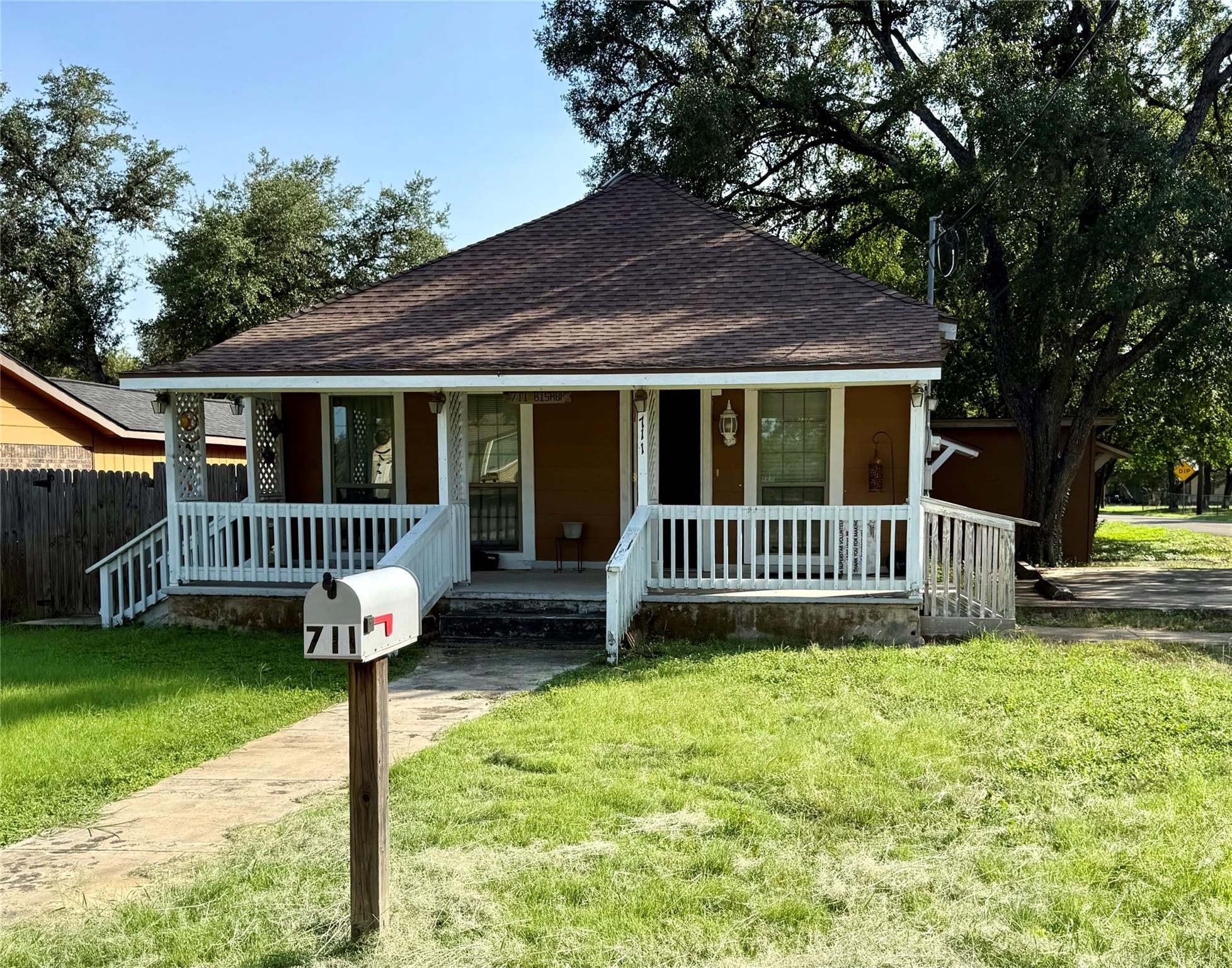 A welcoming front porch with white railings greet