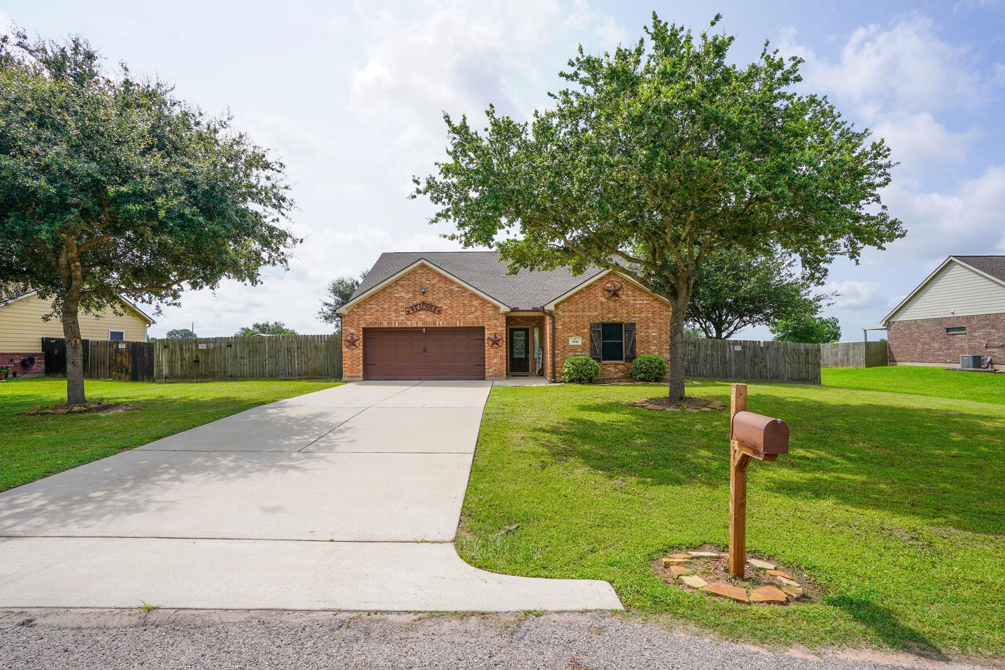 A well-maintained brick facade and verdant lawn w