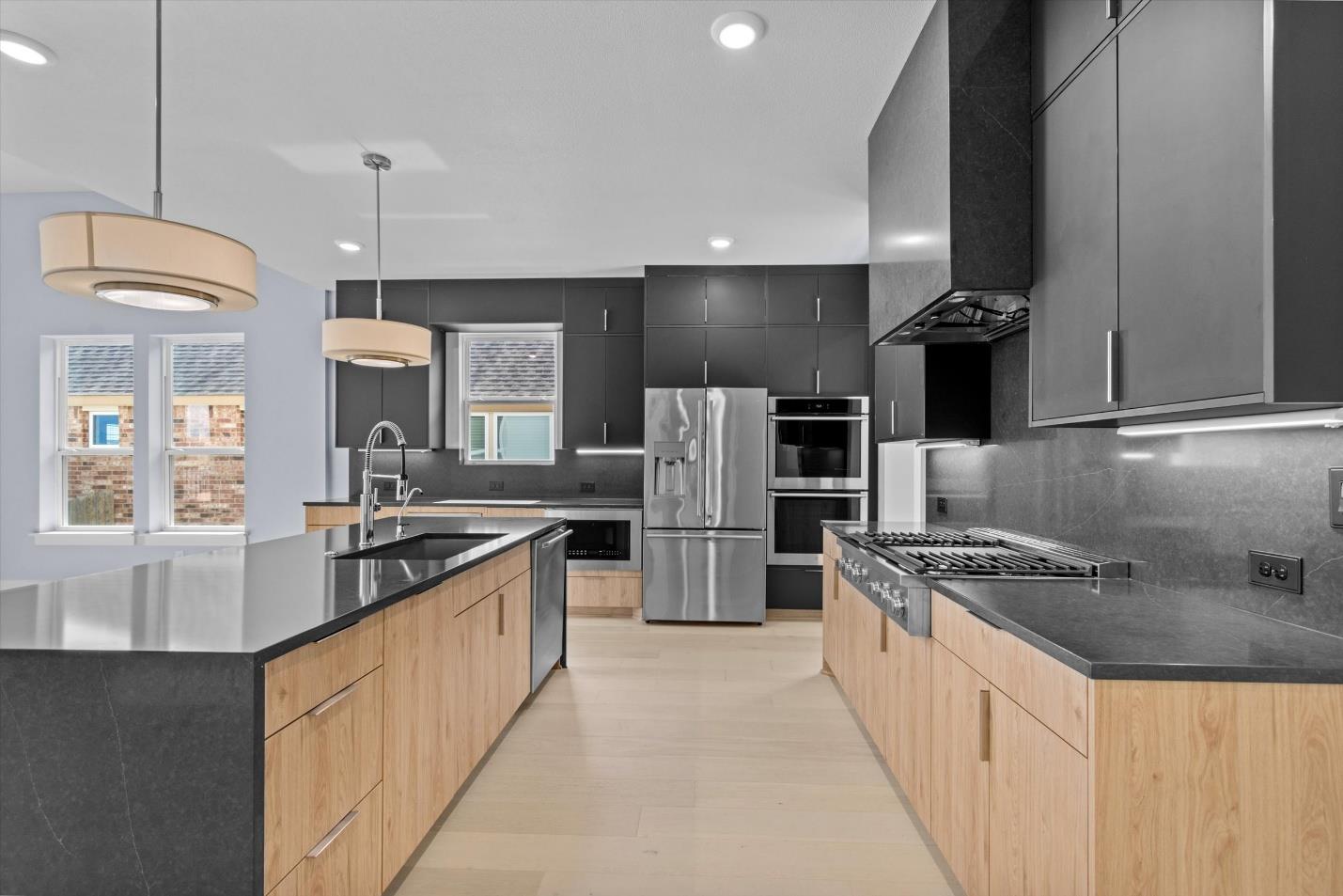 Sleek contemporary cabinetry and expansive stone 