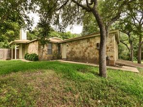 Mature trees shade this charming residence with a