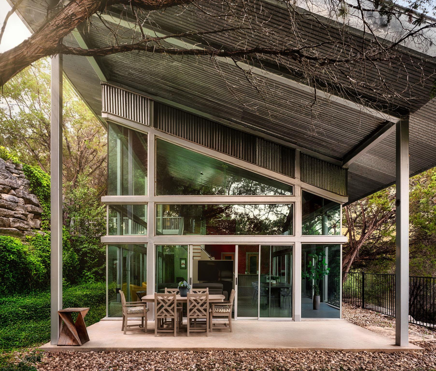 Floor-to-ceiling windows illuminate this contempo