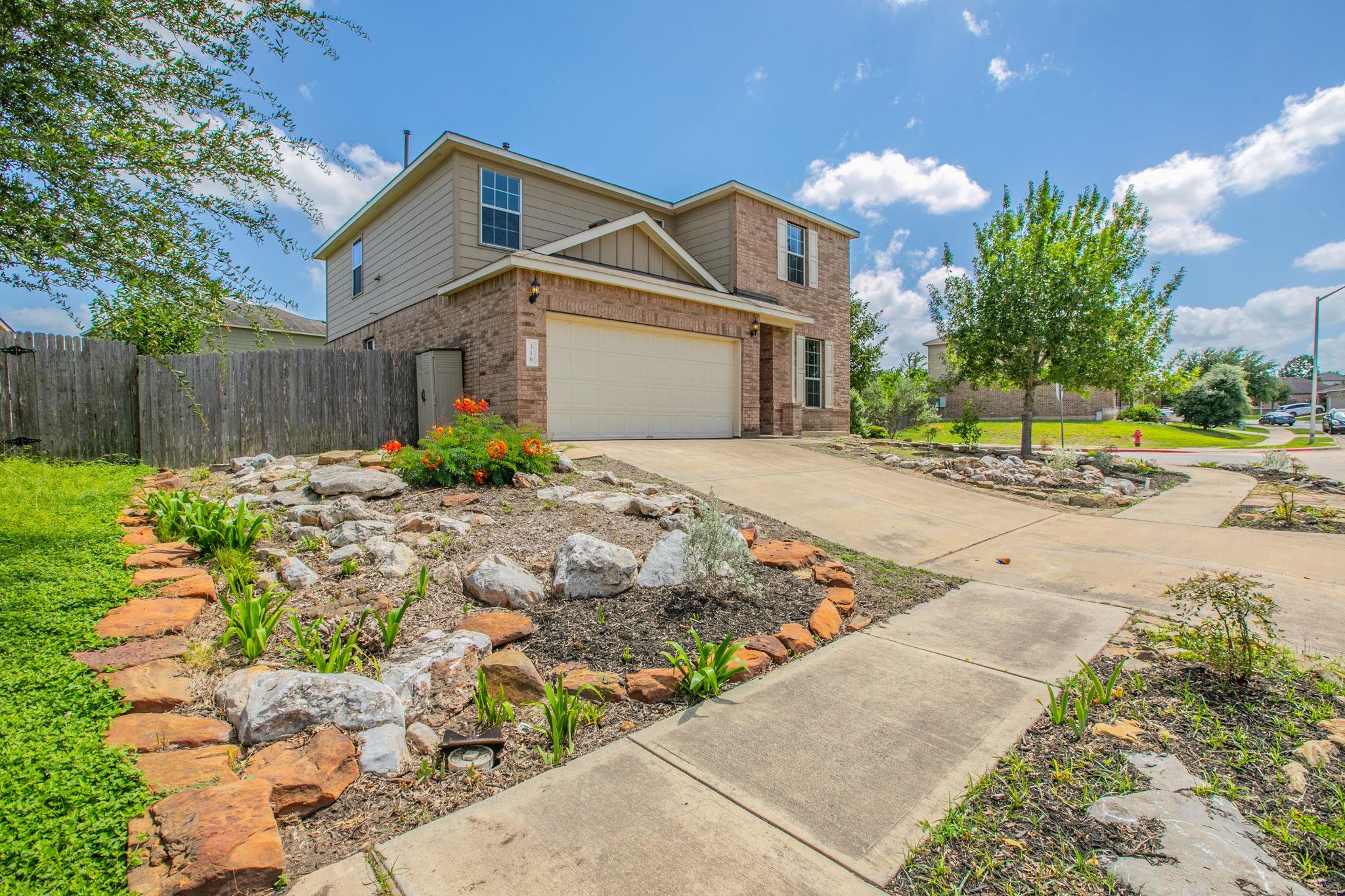 A well-maintained brick and siding facade with an
