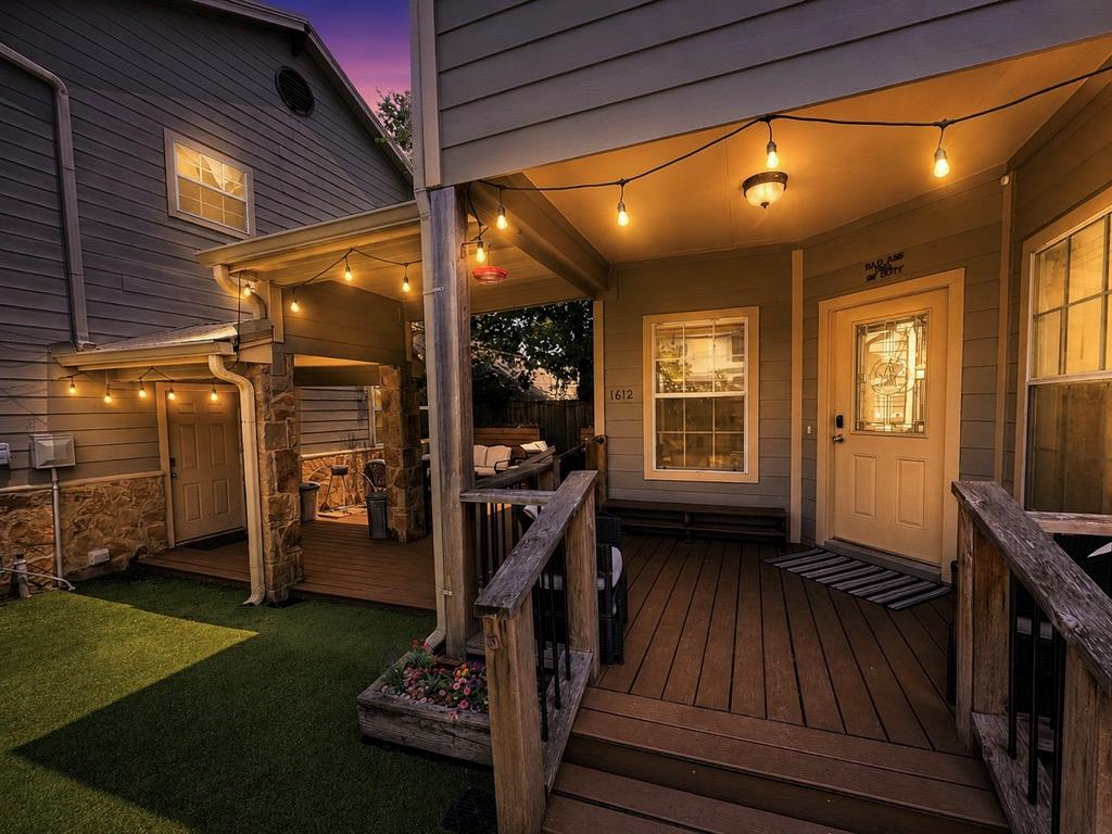An inviting porch and deck, well-lit for evening 