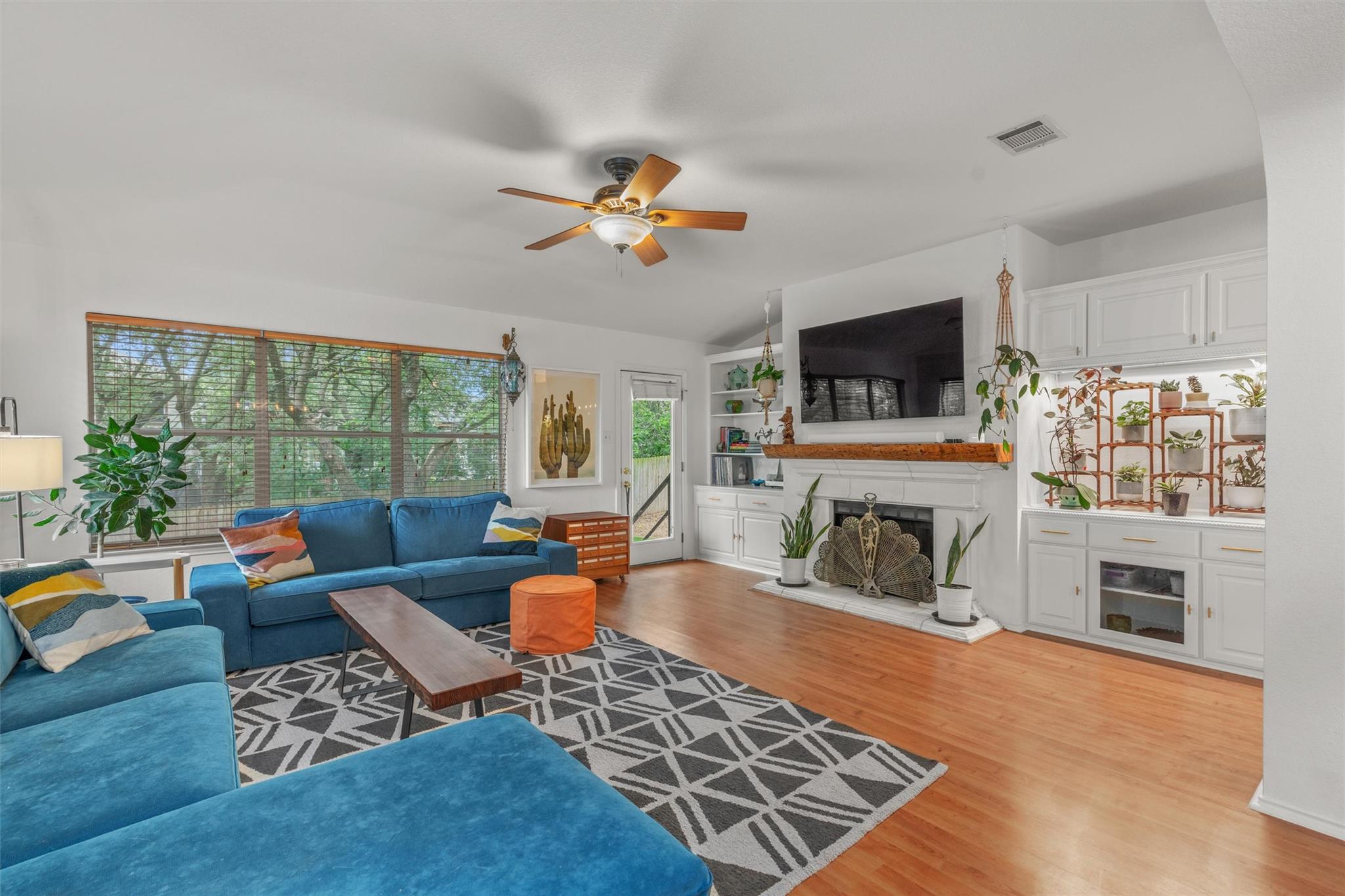 Hardwood floors and a welcoming fireplace with bu