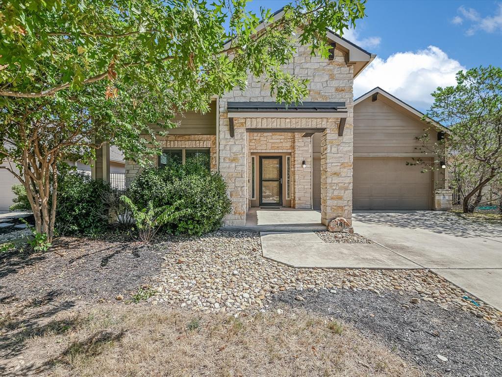 A stone facade and integrated garage offer appeal