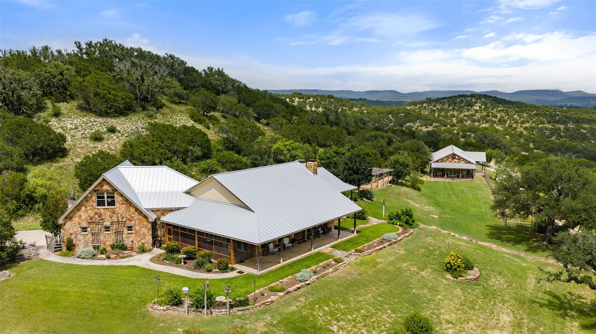 Perched on a verdant hillside, this stone and met