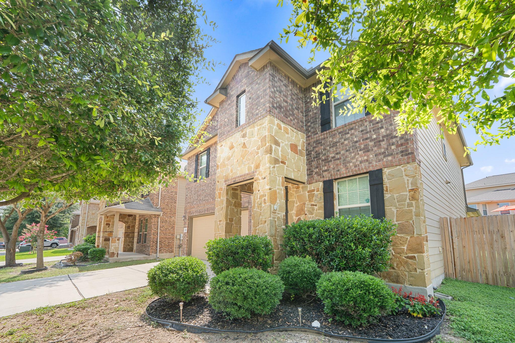 A charming exterior combines brick and stone acce