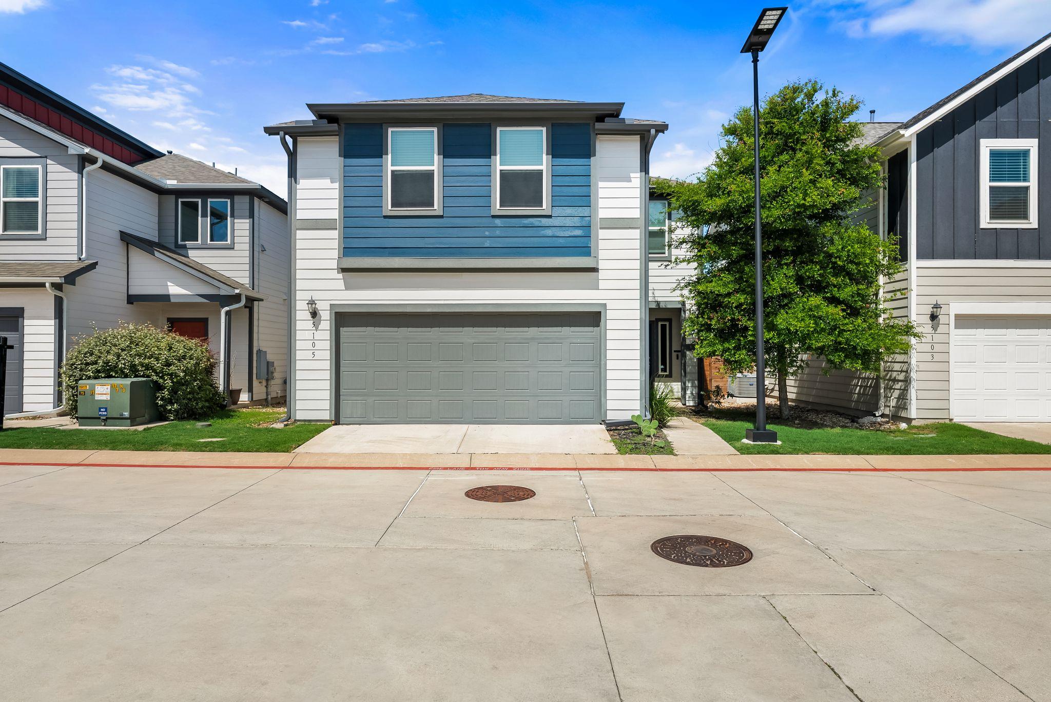 A modern facade with blue and white siding and an