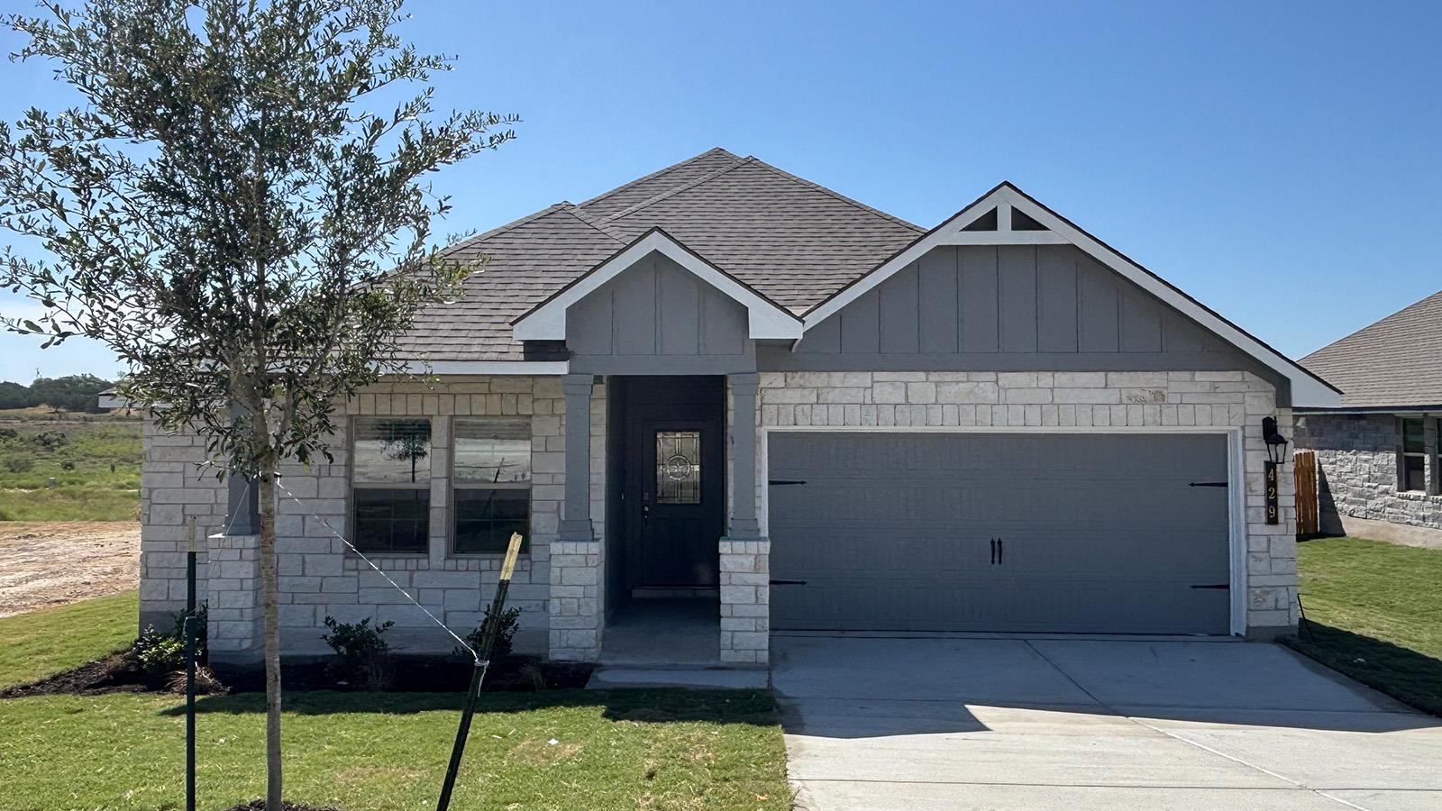 Limestone masonry and gabled rooflines create exc