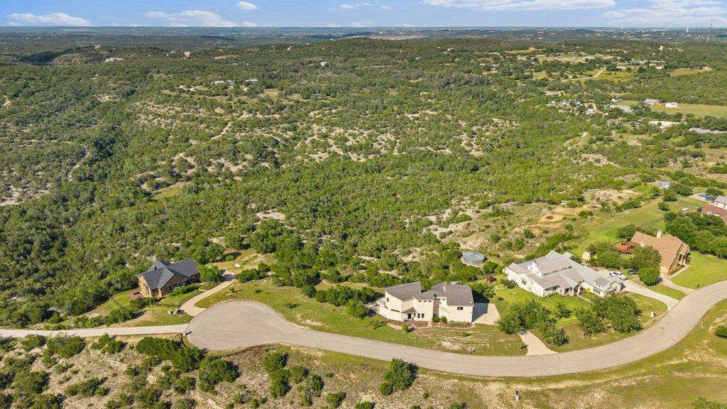 Perched atop rolling hills, a cluster of homes do