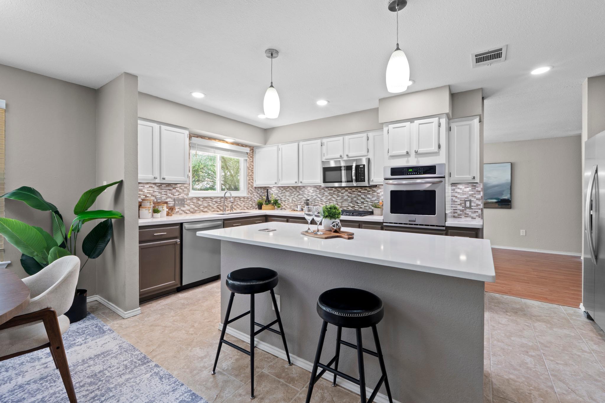 A well-lit kitchen with sleek stainless steel app