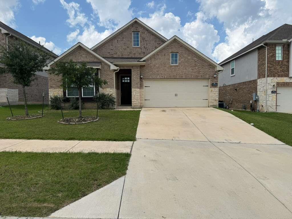 A well-maintained lawn and extended concrete driv