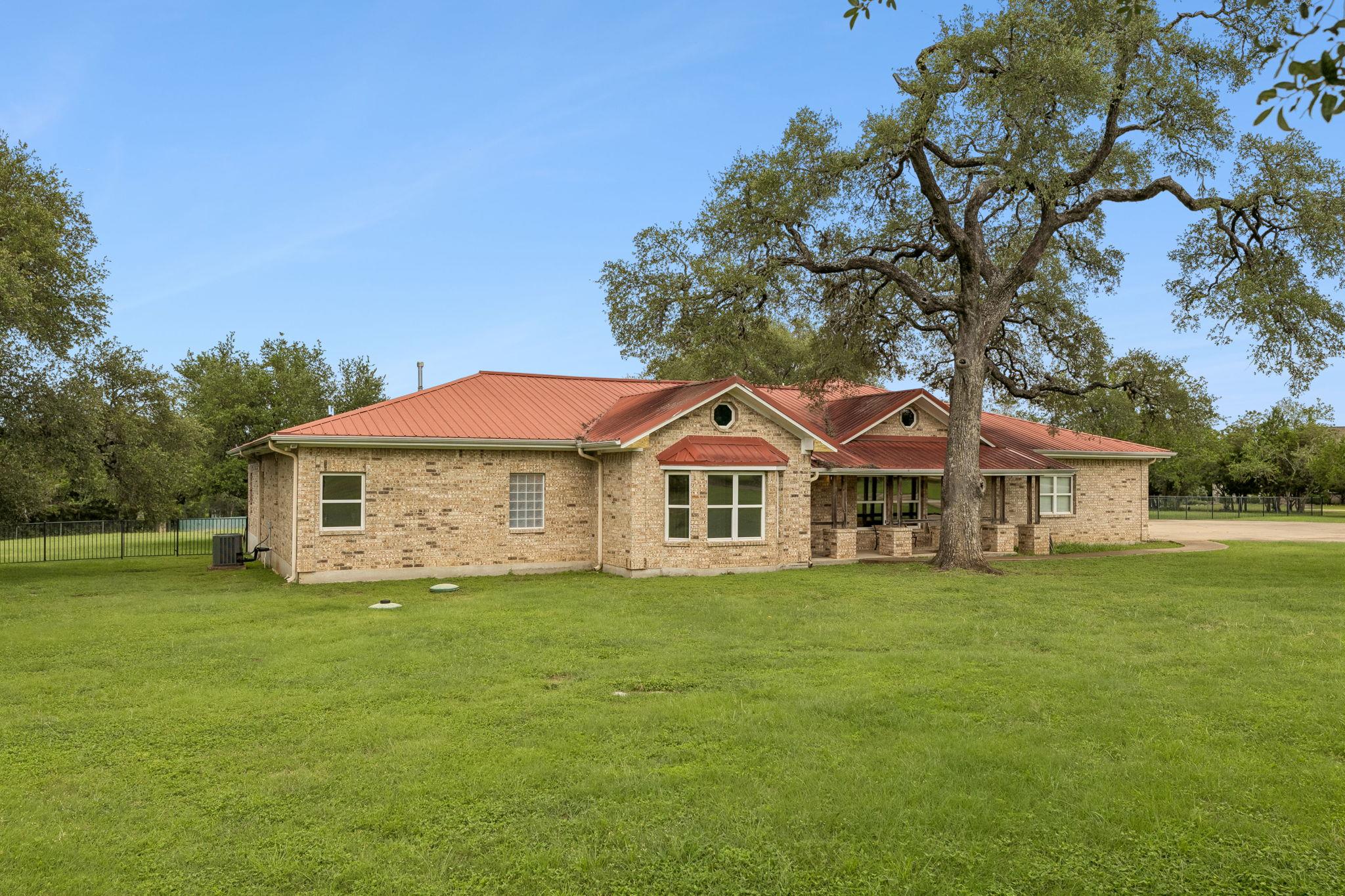 A classic brick exterior and a vibrant red roof d