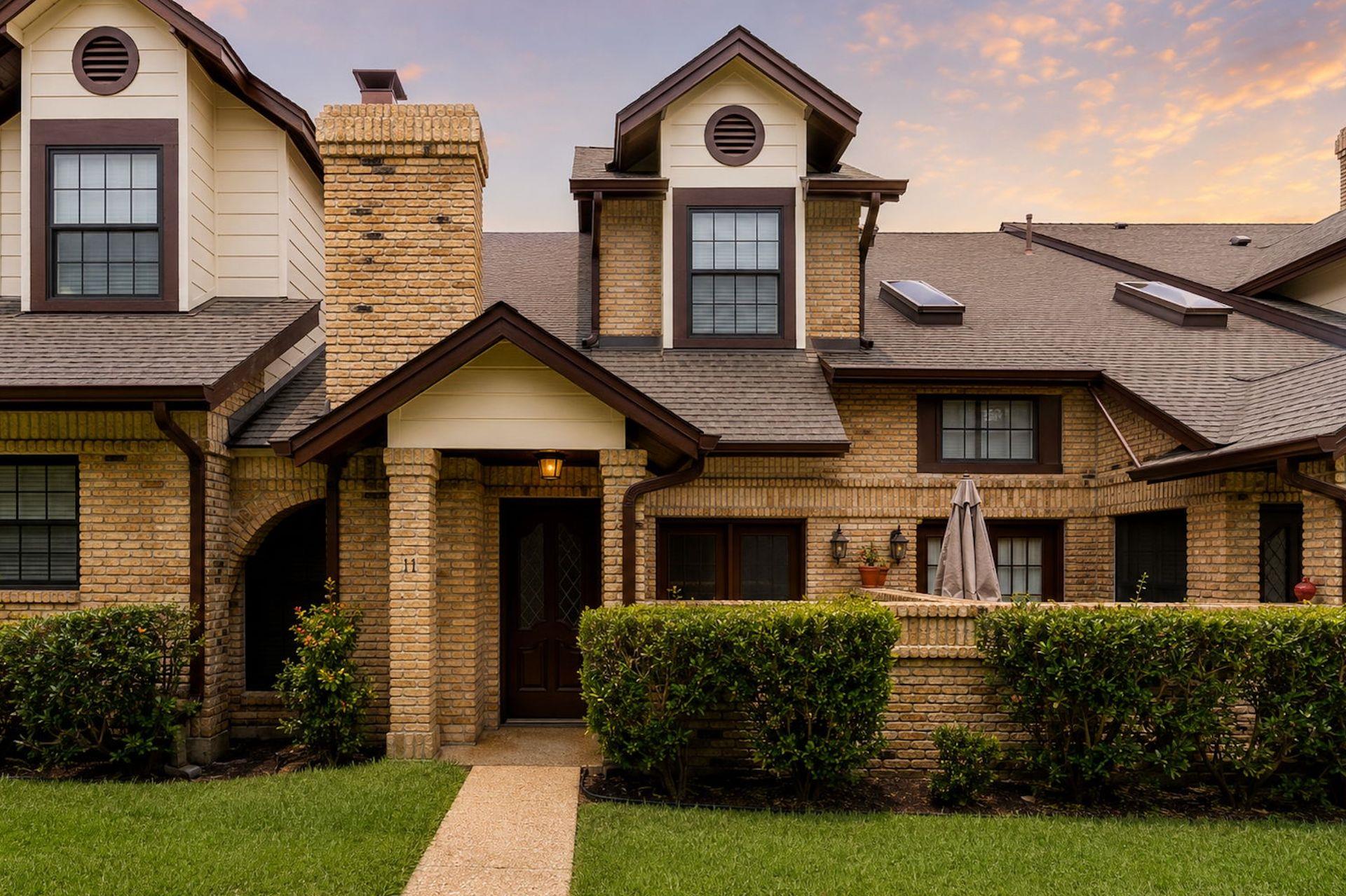 Textured brickwork, multiple gables, and neat lan