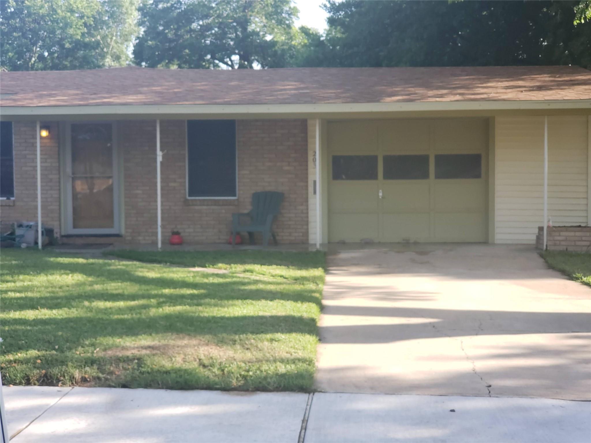 An inviting brick facade with a detached garage o