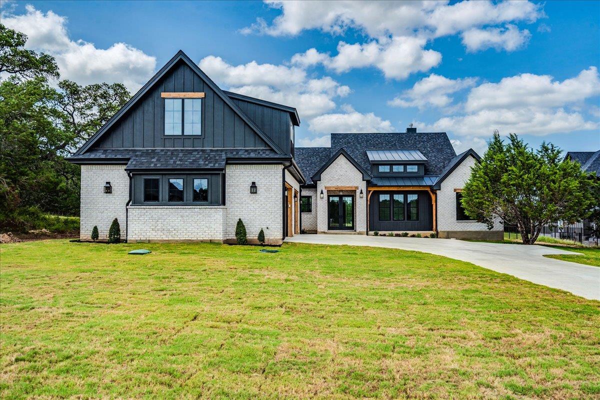 A striking modern farmhouse boasts a clean-lined 