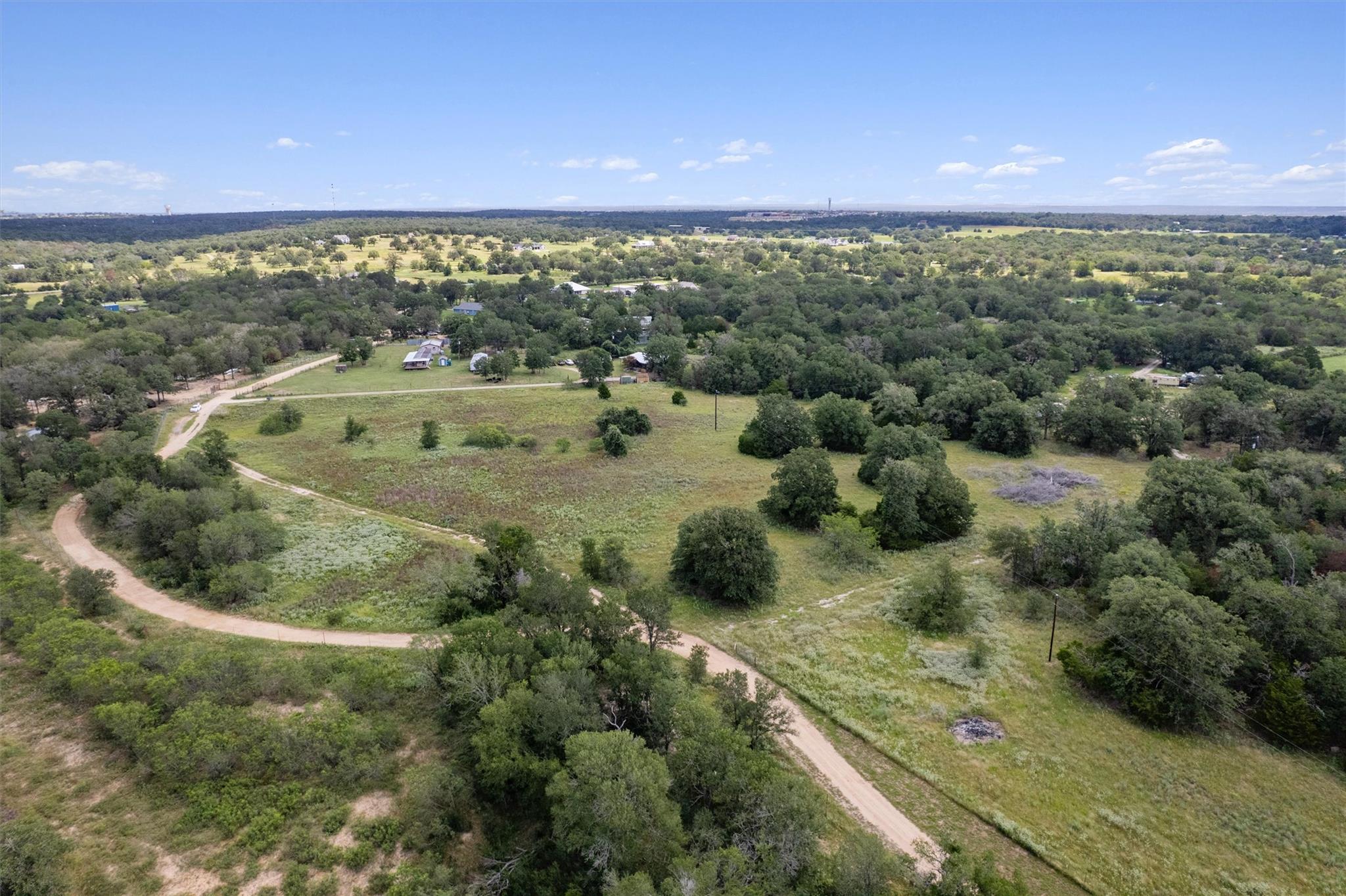 A tranquil, sprawling rural landscape unfolds wit