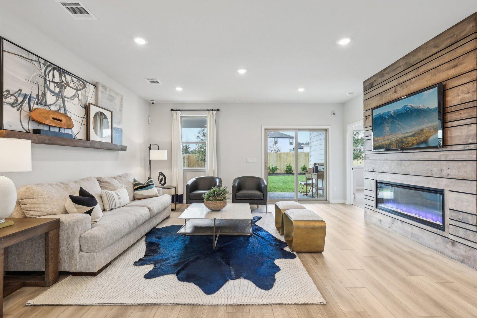 A well-lit living area showcases light hardwood f