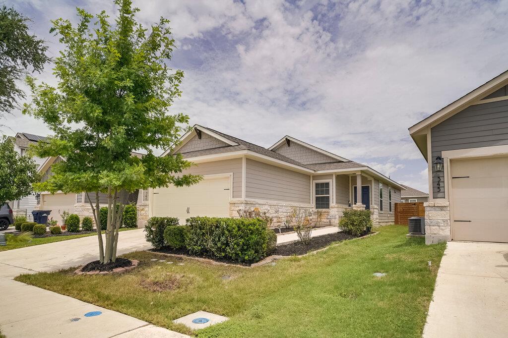 A neatly manicured lawn frames this charming home