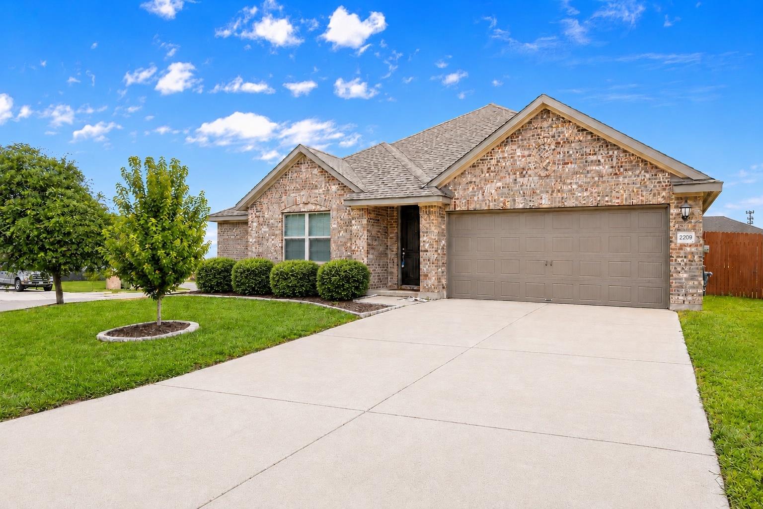 A well-maintained lawn and sturdy brick exterior 